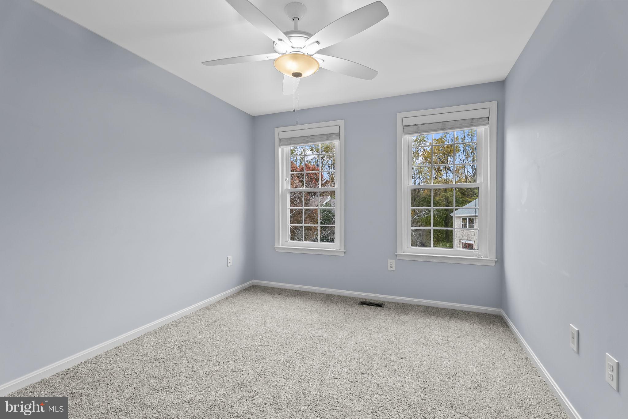 6267 Taliaferro Way Alexandria, VA 22315 - Photo 27 of 49 an empty room with chandelier fan and windows