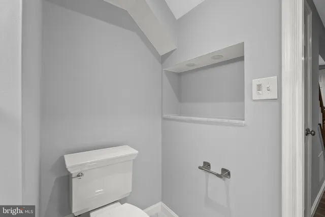 a white toilet sitting next to a shower