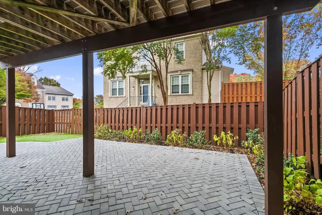 a view of a house with a small yard and wooden fence