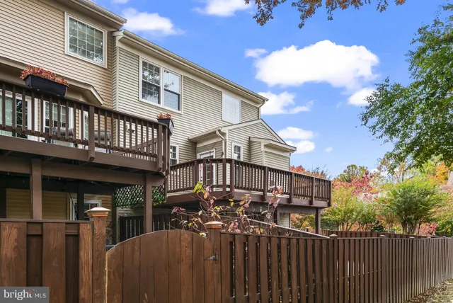 a view of a house with wooden fence