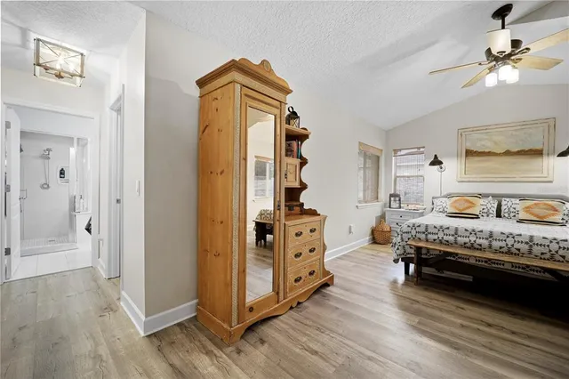 a bedroom with furniture and wooden floor
