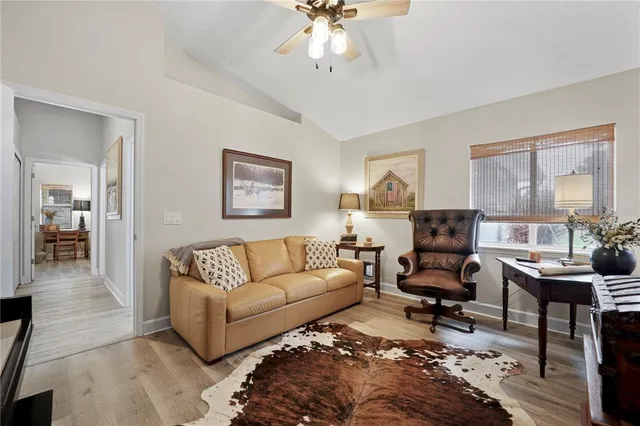 a living room with furniture a rug and a chandelier