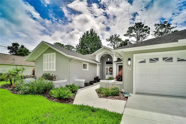 a front view of a house with garden