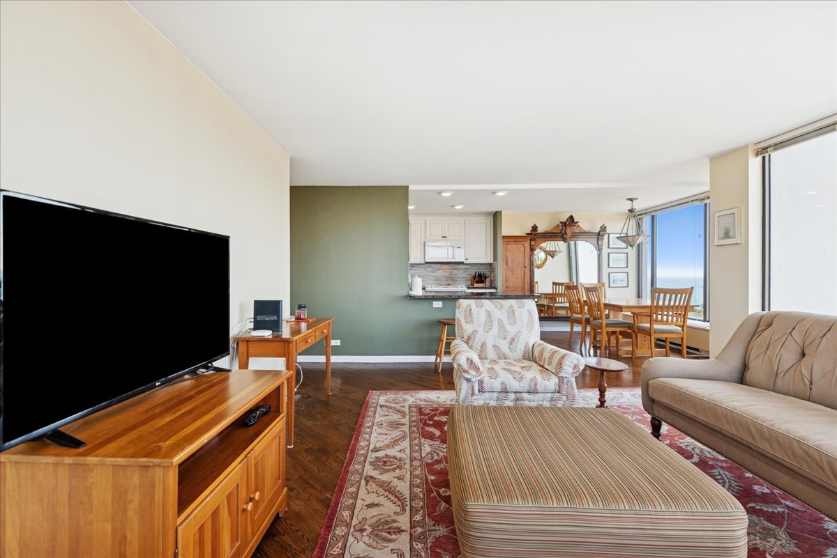 5455 North Sheridan Road, Unit 26122615 Chicago, IL 60640 - Photo 12 of 27 a living room with furniture and a flat screen tv