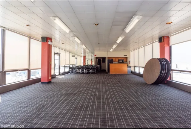 a view of a chair and table in backyard of the house