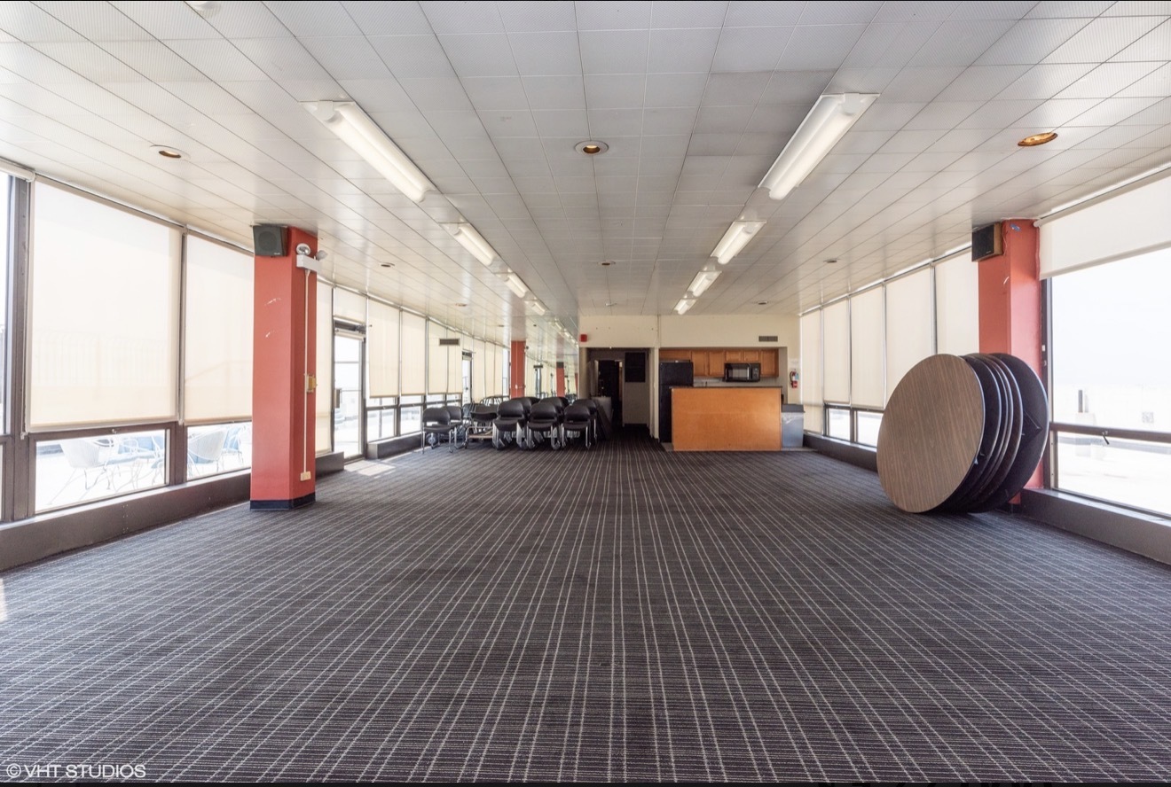 5455 North Sheridan Road, Unit 26122615 Chicago, IL 60640 - Photo 23 of 27 a view of an empty room with a window and wooden floor