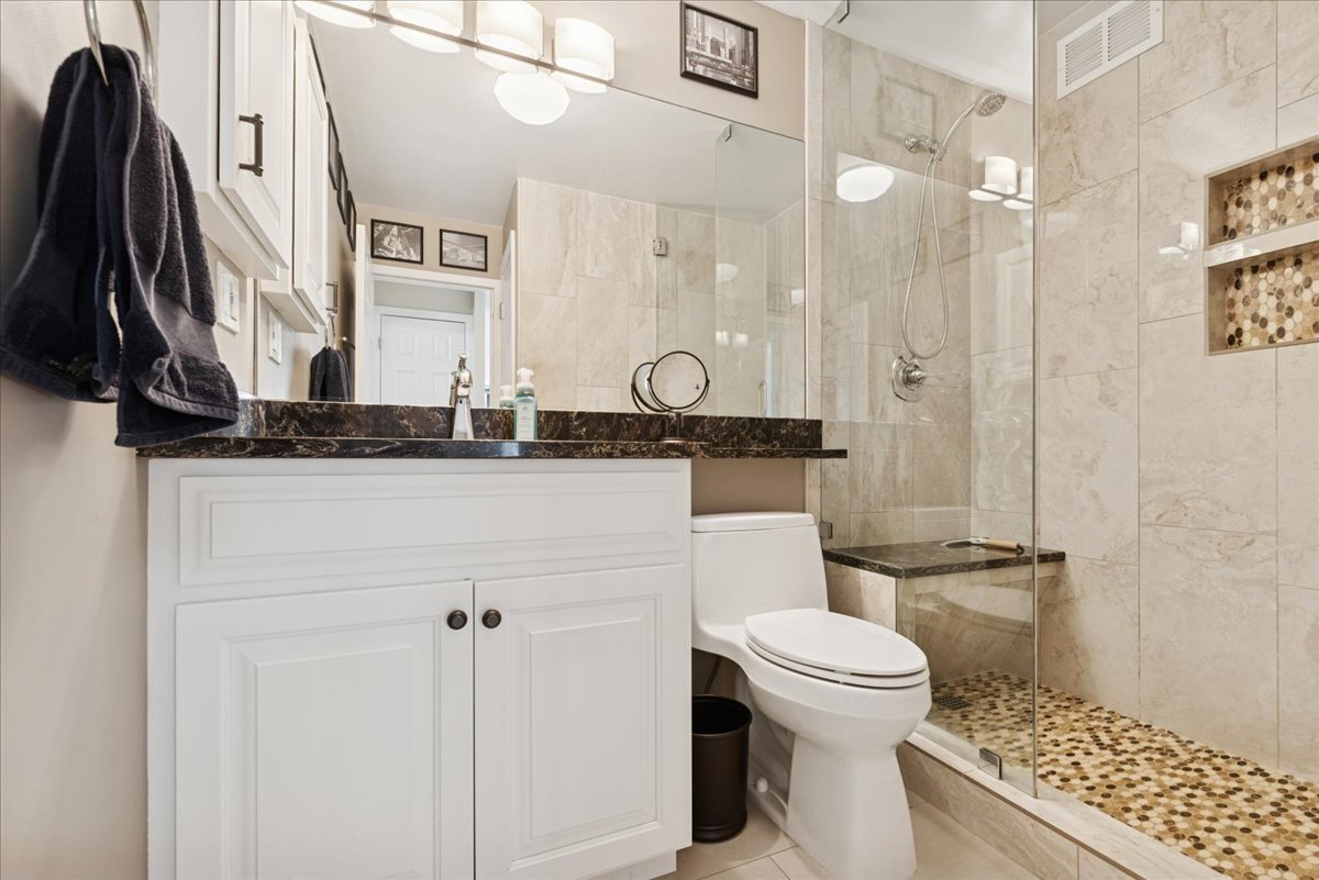 5455 North Sheridan Road, Unit 26122615 Chicago, IL 60640 - Photo 8 of 27 a bathroom with a sink a toilet and a mirror