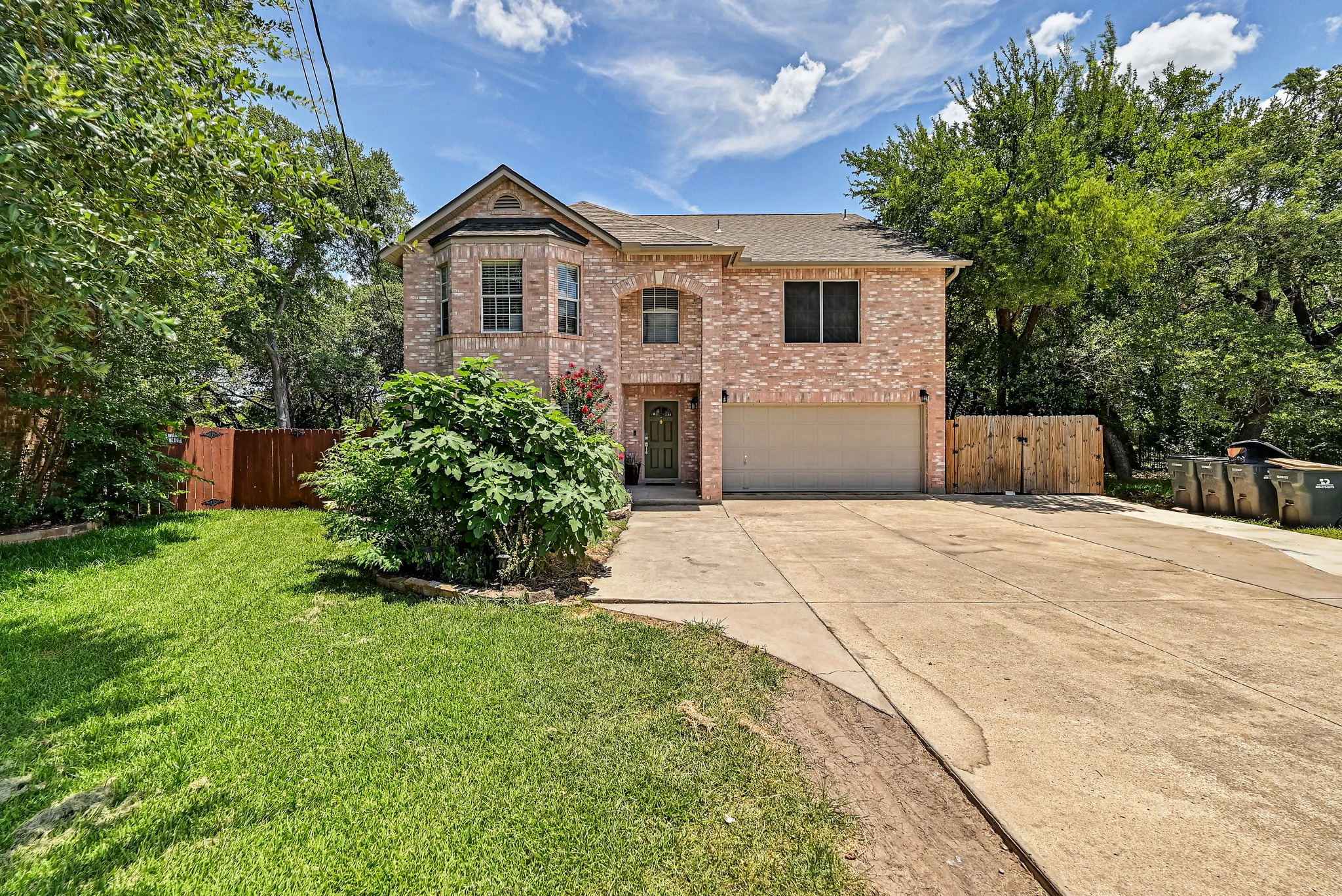 104 North Sumac Lane Georgetown, TX 78633 - Photo 2 of 40 A classic brick exterior with a welcoming entryway and an attached garage provides inviting curb appeal.
