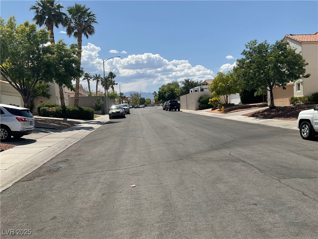 7620 Donald Nelson Avenue Las Vegas, NV 89131 - Photo 32 of 34 View of asphalt street featuring sidewalks, street lights, curbs, and a residential view