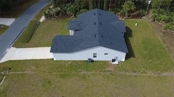 an aerial view of a house with a yard