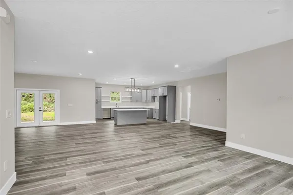 a view of kitchen with wooden floor electronic appliances and window