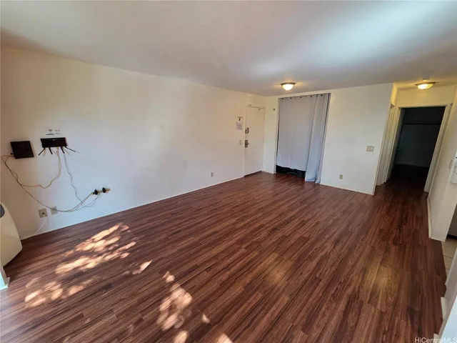 a view of a room with wooden floor and a sink