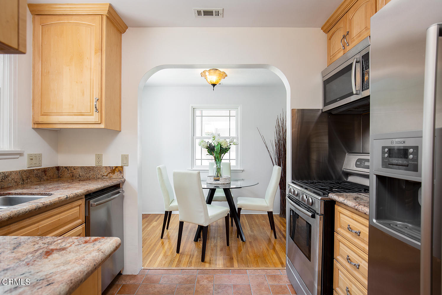 2766 Millicent Way Pasadena, CA 91107 - Photo 11 of 20 a kitchen with stainless steel appliances granite countertop a stove top oven a sink a dining table and chairs