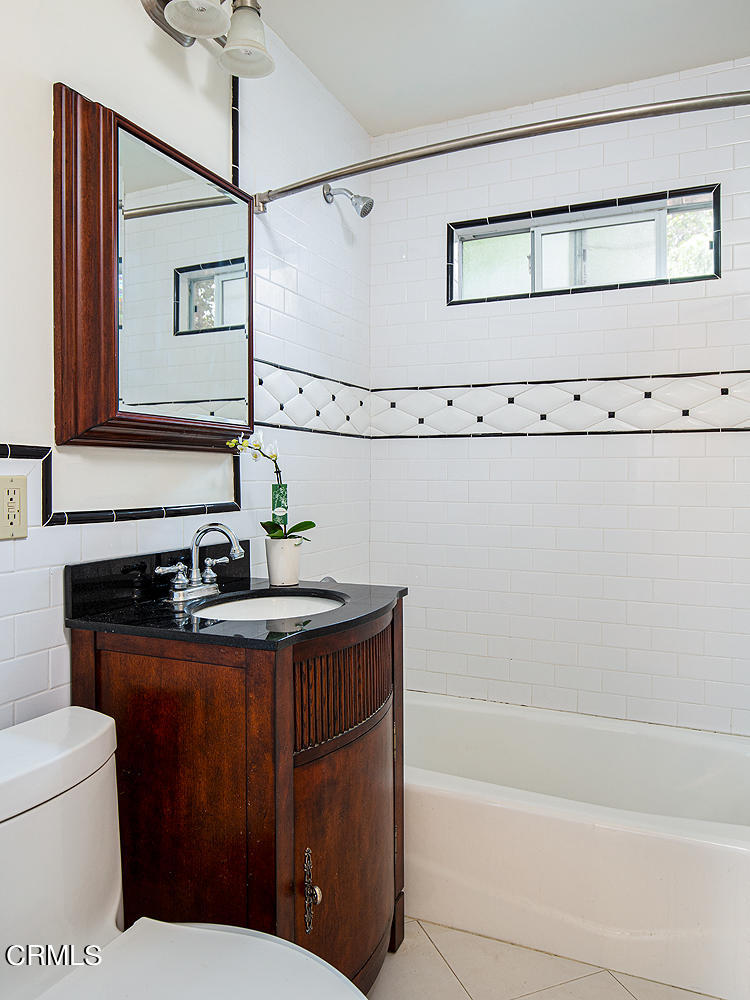 2766 Millicent Way Pasadena, CA 91107 - Photo 15 of 20 a bathroom with a sink a mirror and a bathtub