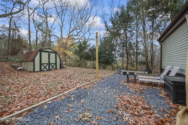 a view of a house with a yard and sitting area