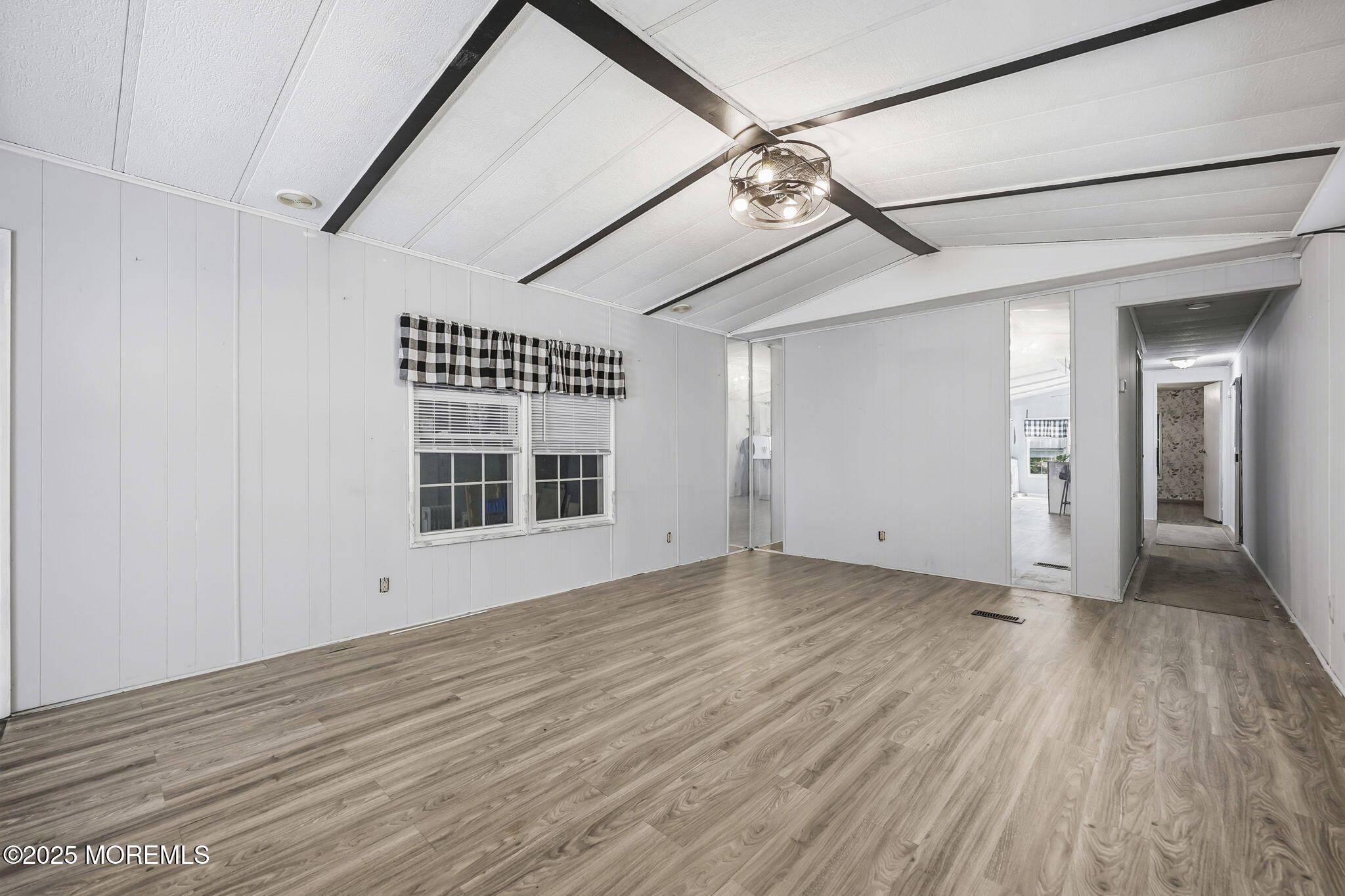 6 Taft Street Howell, NJ 07731 - Photo 7 of 22 an empty room with wooden floor chandelier and windows