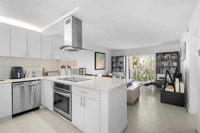 a view of a kitchen with sink stove and cabinets