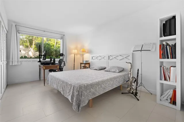 a bed room with a bed and a large window