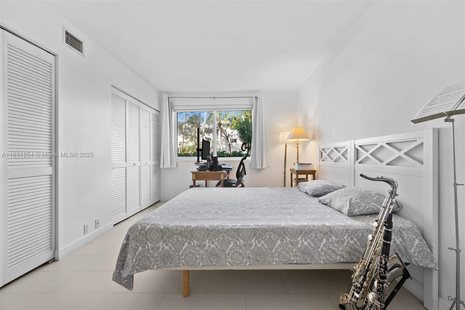 240 Galen Drive, Unit 109 Key Biscayne, FL 33149 - Photo 17 of 30 a bedroom with a bed and window