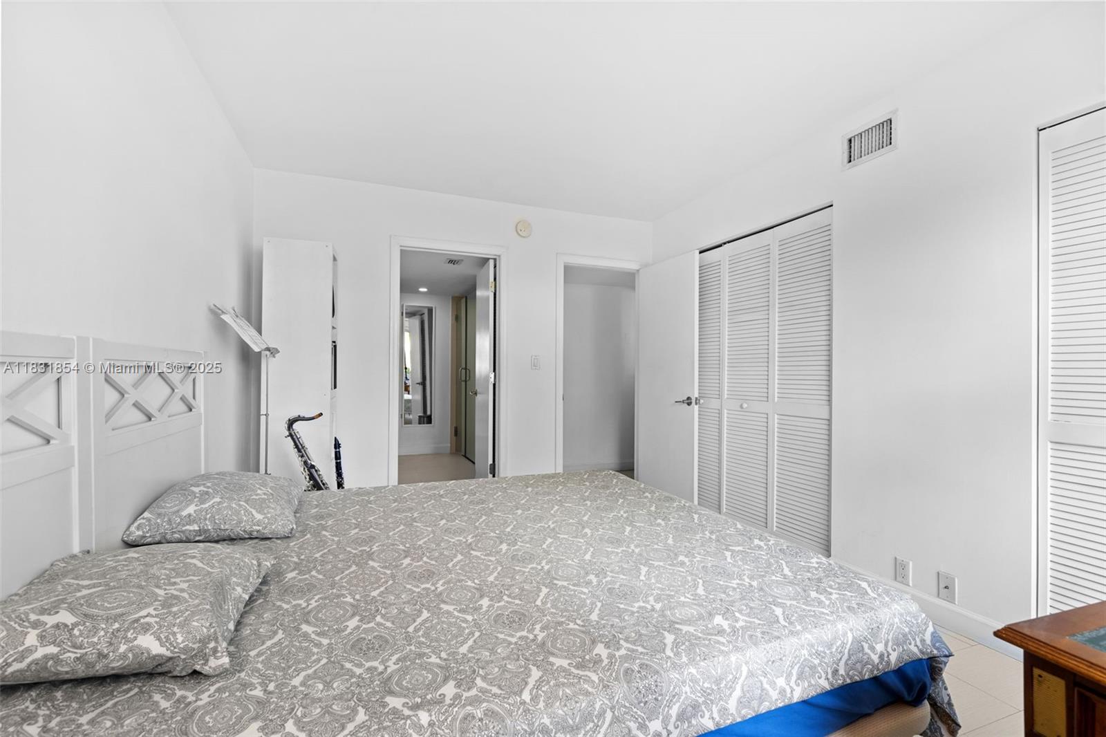 240 Galen Drive, Unit 109 Key Biscayne, FL 33149 - Photo 19 of 30 a bedroom with a bed and a window