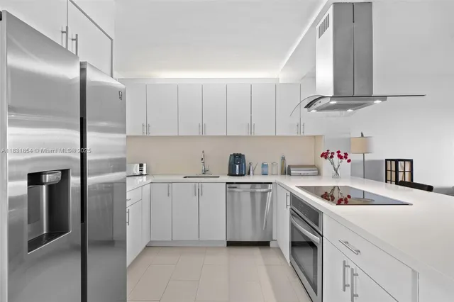 a kitchen with a sink dishwasher a refrigerator and cabinets