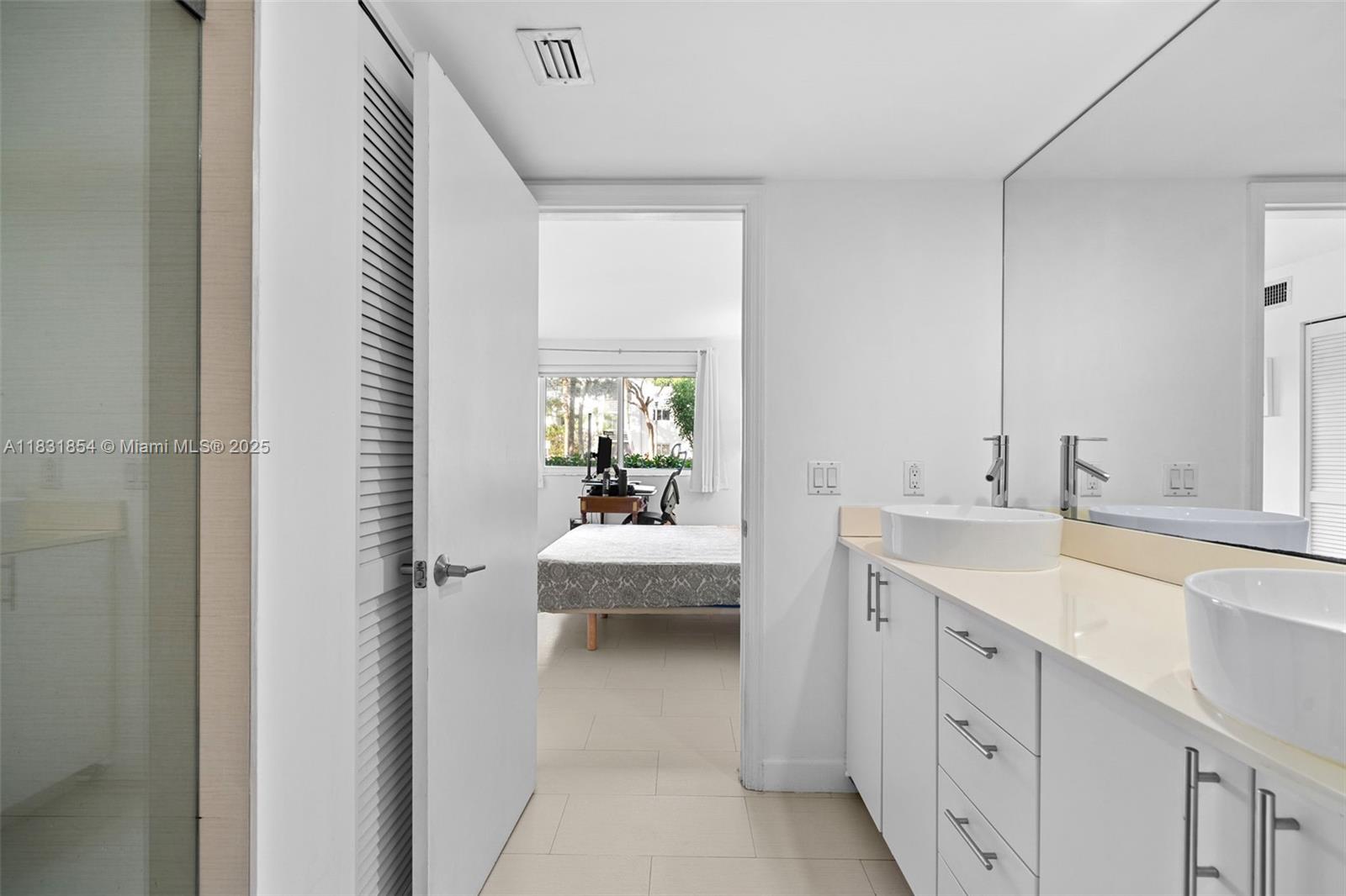 240 Galen Drive, Unit 109 Key Biscayne, FL 33149 - Photo 21 of 30 a en suite bathroom with a sink a mirror and a bathtub