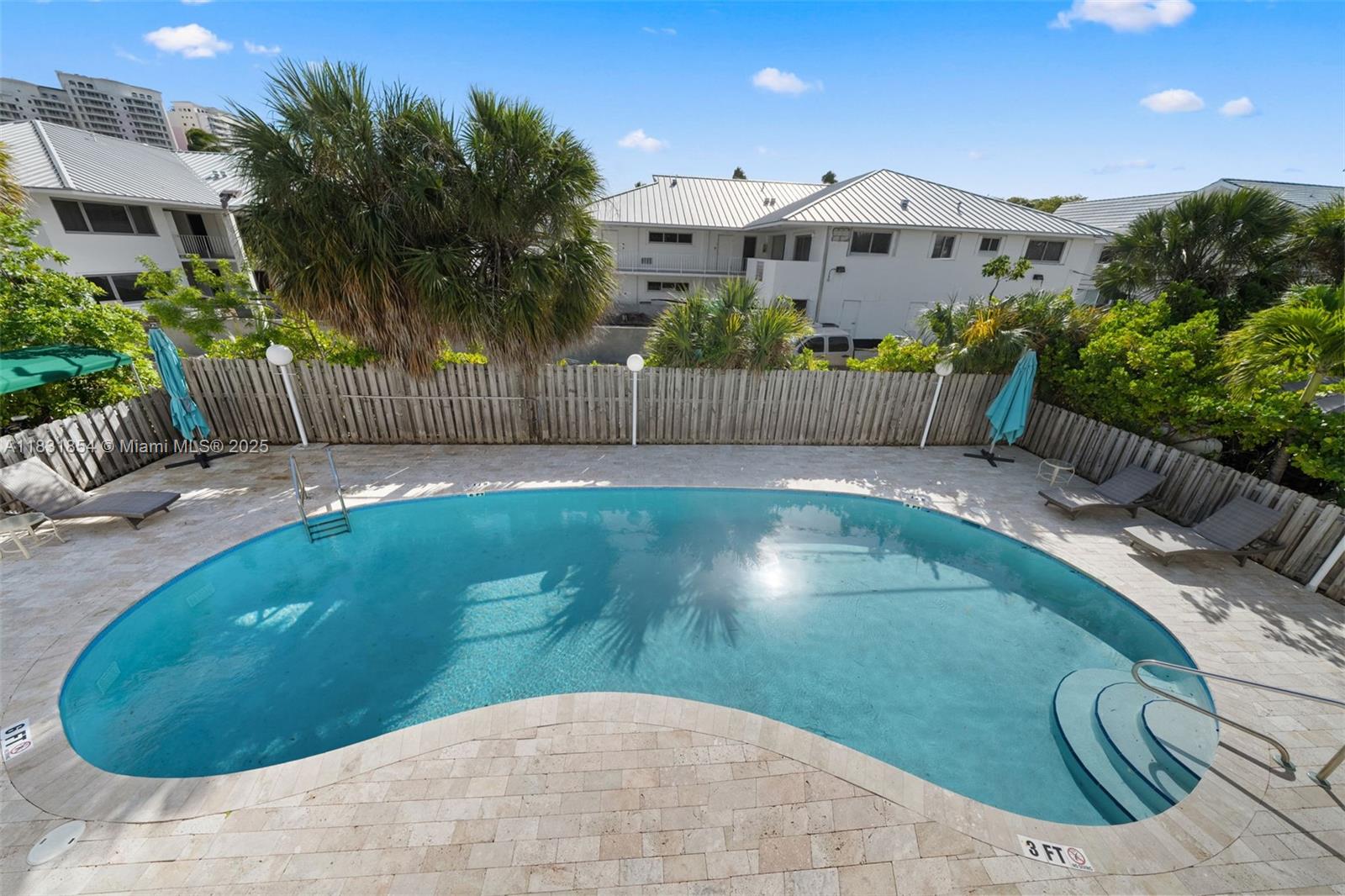 240 Galen Drive, Unit 109 Key Biscayne, FL 33149 - Photo 25 of 30 a view of a backyard with plants and outdoor seating