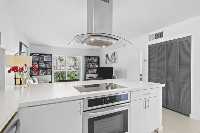 a kitchen that has a sink and a stove in it