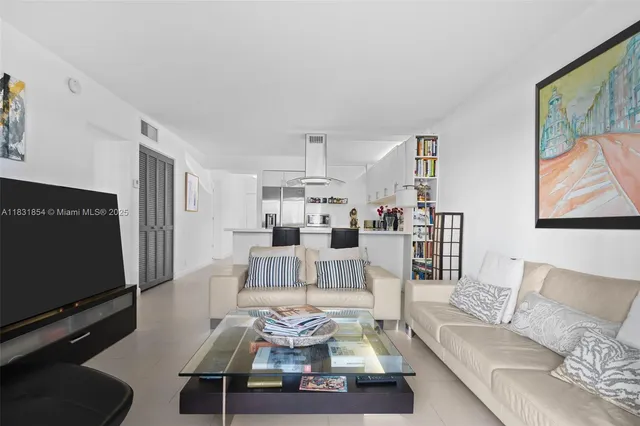 a living room with furniture wooden floor and a flat screen tv