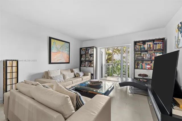 a living room with furniture large window and a flat screen tv