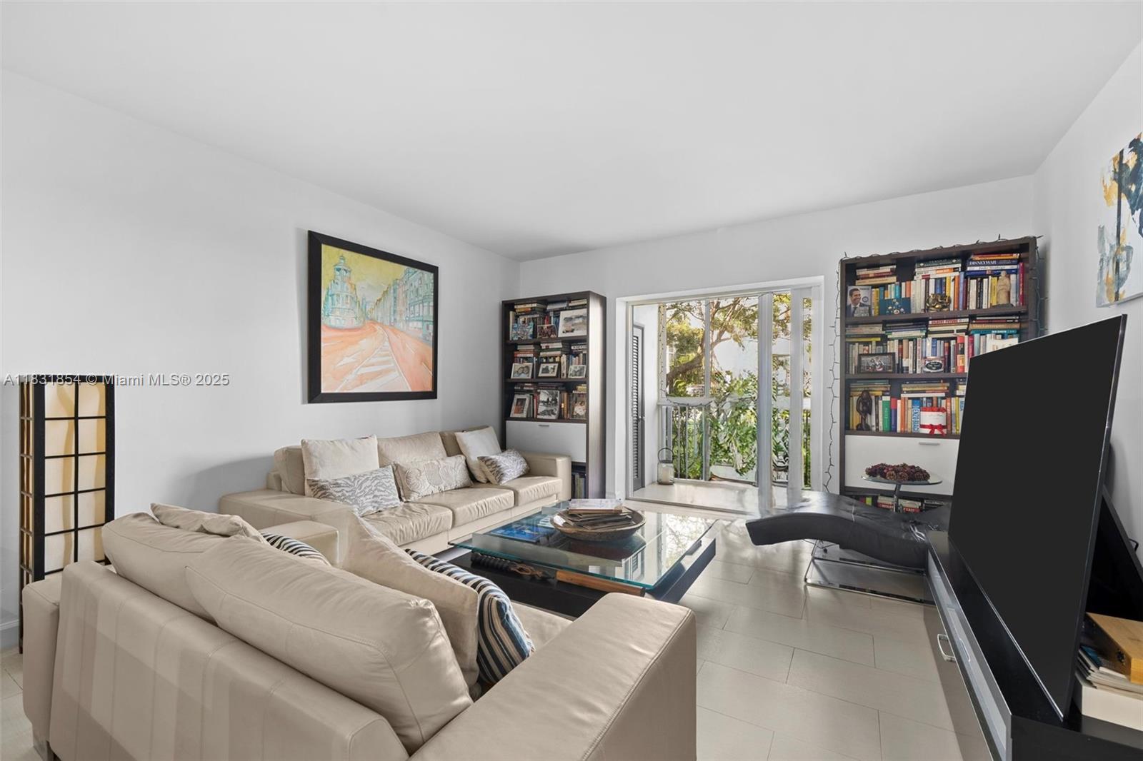 240 Galen Drive, Unit 109 Key Biscayne, FL 33149 - Photo 6 of 30 a living room with furniture large window and a flat screen tv