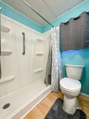 a bathroom with a toilet and a shower