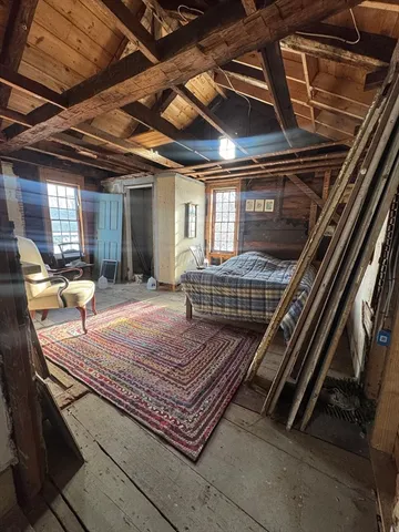 a view of a gym with wooden roof and sitting space