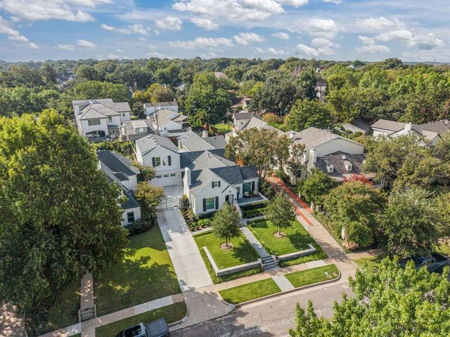 an aerial view of residential houses with outdoor space and swimming pool