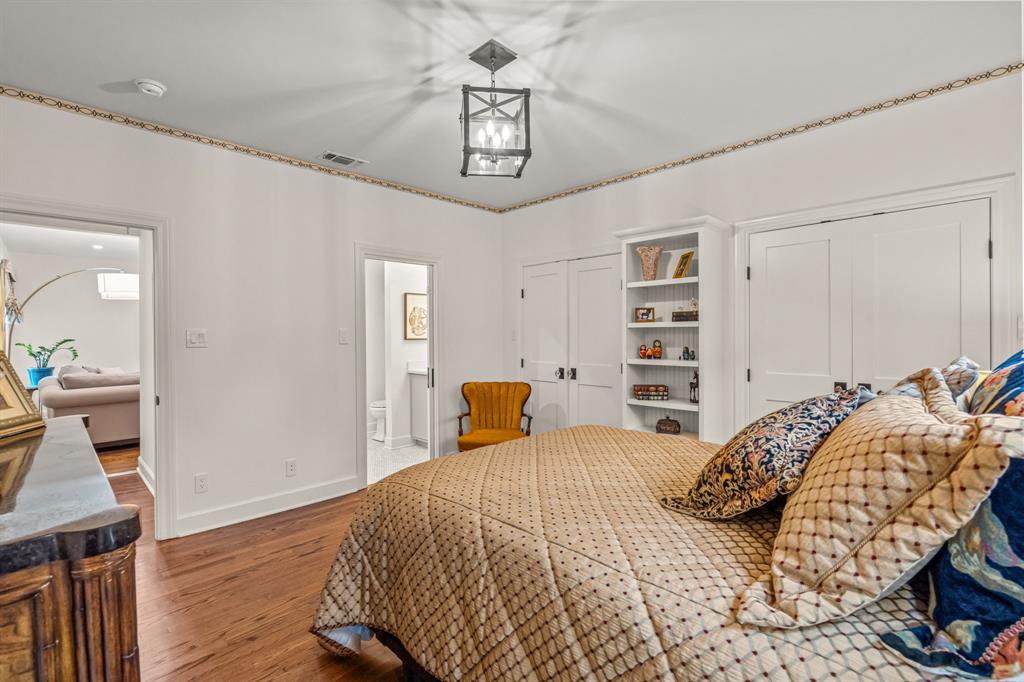 3913 Hamilton Avenue Fort Worth, TX 76107 - Photo 22 of 40 a bedroom with a bed a dresser and book shelf