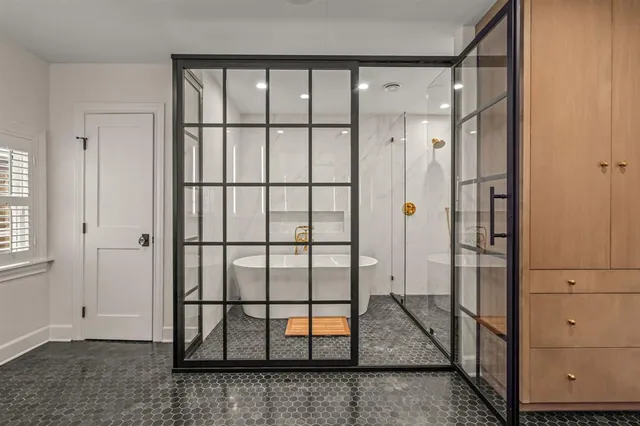 a en suite bathroom with a granite countertop sink and a mirror