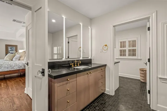 a bathroom with a double vanity sink and mirror