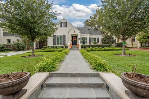a view of a white house with a yard