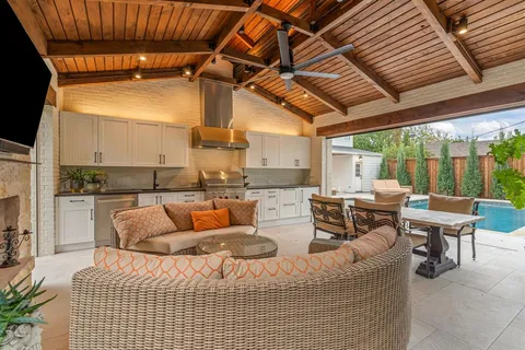 a living room with furniture and kitchen view
