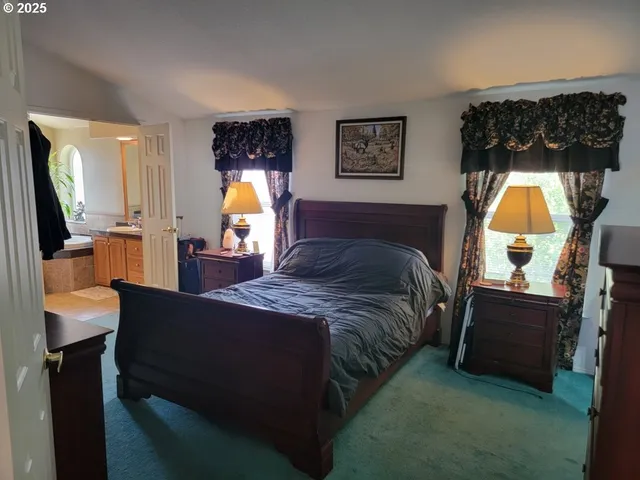 a bedroom with double bed and a lamp