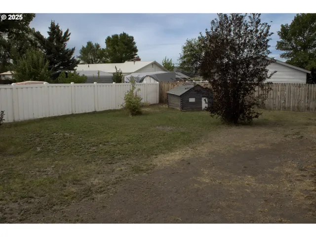 an aerial view of a house with garden space and a car parked