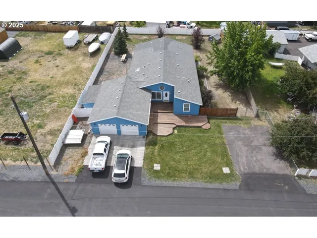 an aerial view of a house with a yard