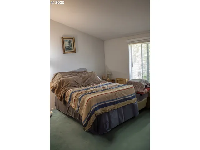 a en suite bathroom with a granite countertop sink and a mirror