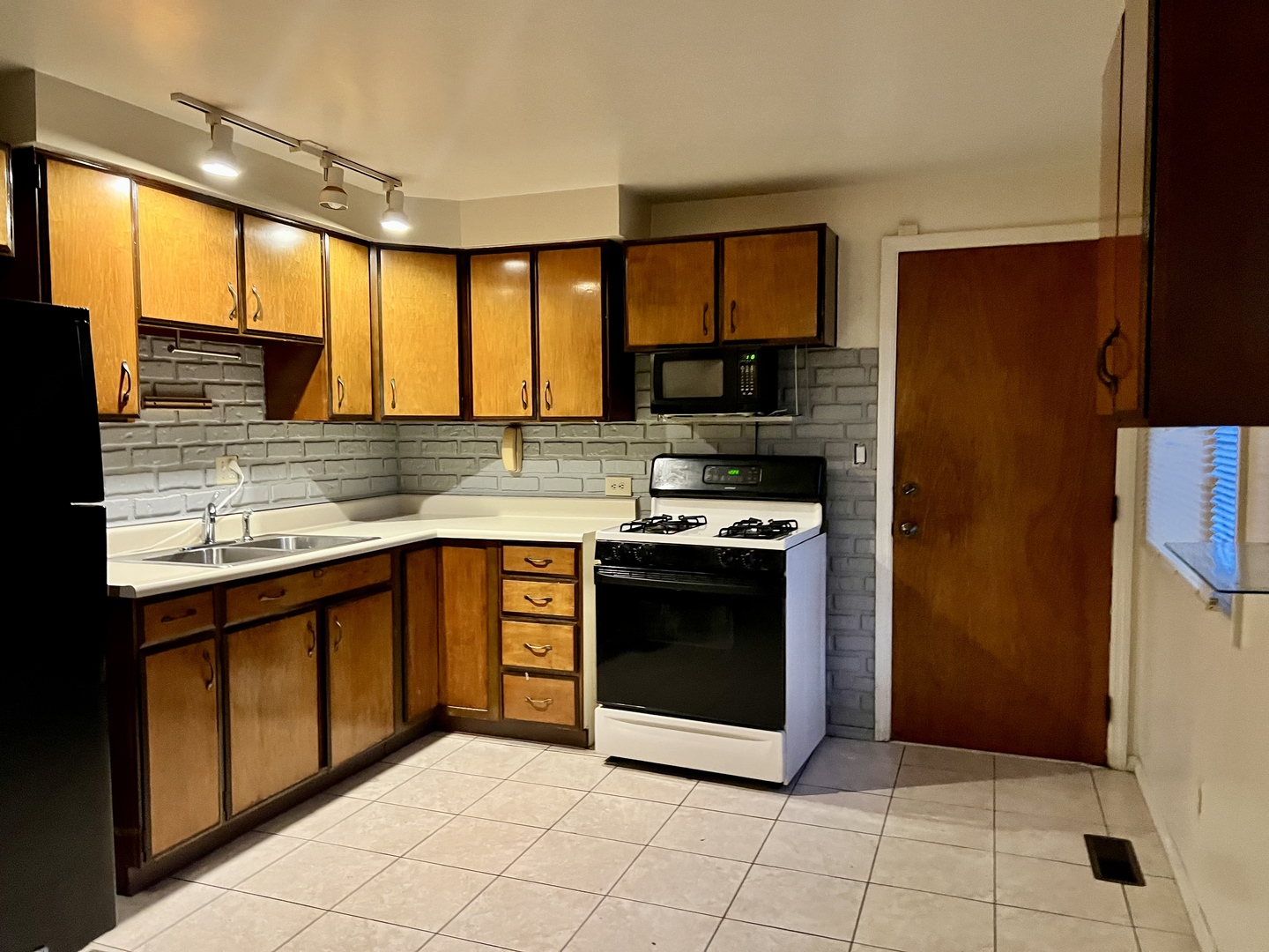 2504 Campbell Drive Champaign, IL 61821 - Photo 11 of 24 a kitchen with stainless steel appliances granite countertop a stove a sink and a microwave