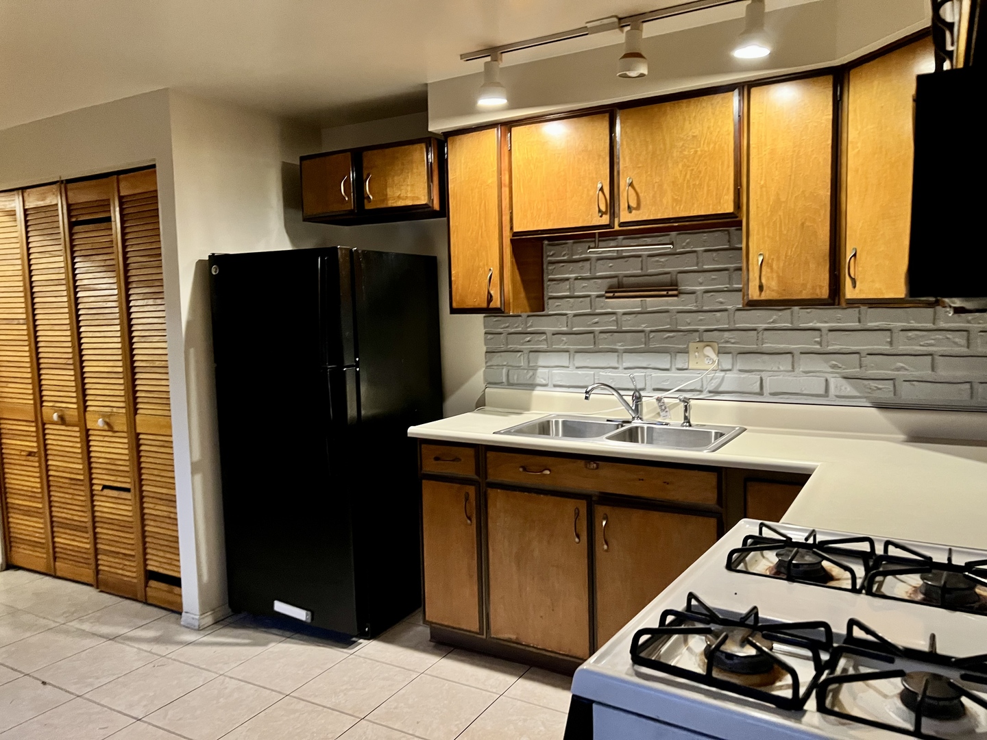 2504 Campbell Drive Champaign, IL 61821 - Photo 12 of 24 a kitchen with a sink and a refrigerator