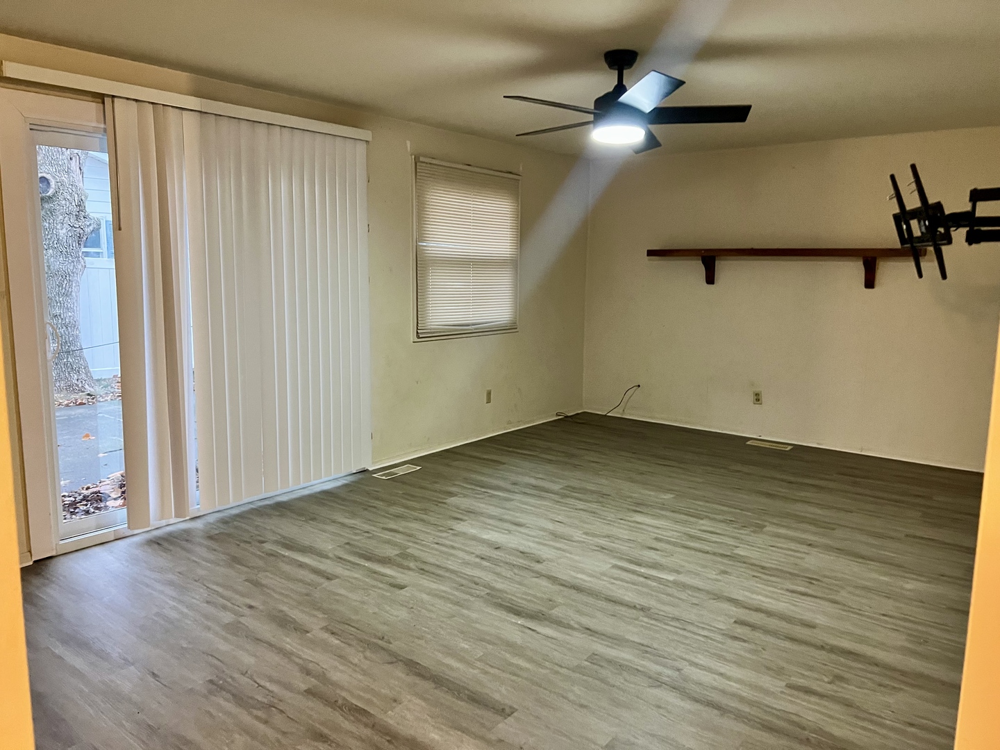 2504 Campbell Drive Champaign, IL 61821 - Photo 4 of 24 an empty room with wooden floor chandelier fan and windows