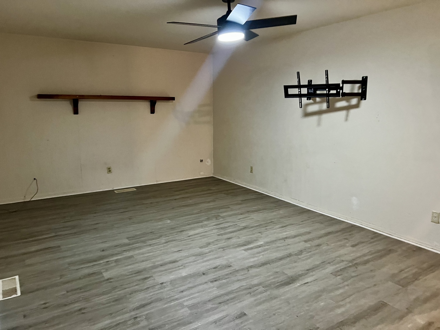 2504 Campbell Drive Champaign, IL 61821 - Photo 5 of 24 an empty room with a ceiling fan and wooden floor