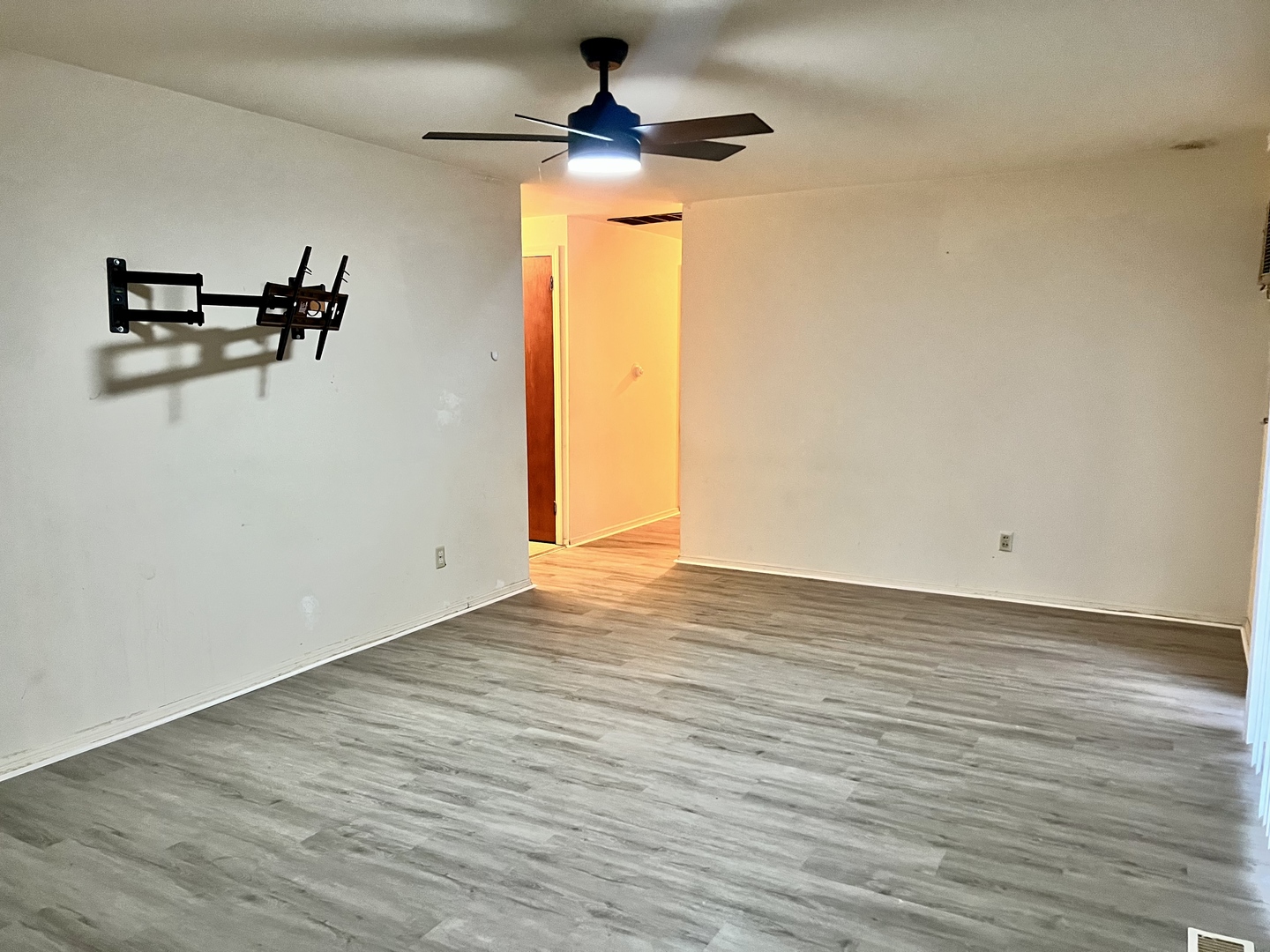 2504 Campbell Drive Champaign, IL 61821 - Photo 7 of 24 an empty room with wooden floor chandelier fan and windows