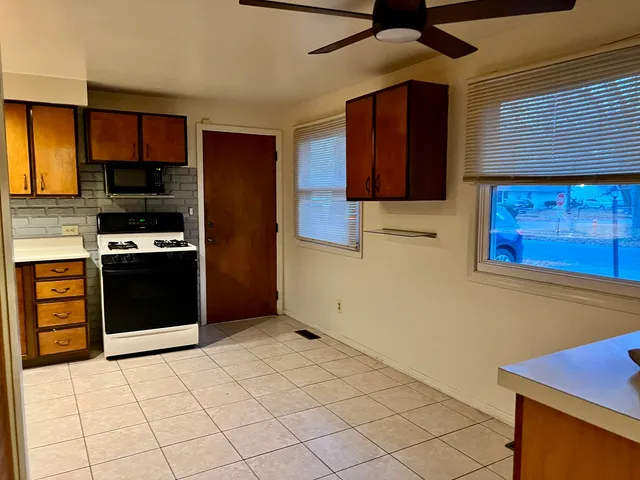 a kitchen with stainless steel appliances granite countertop a stove and a refrigerator