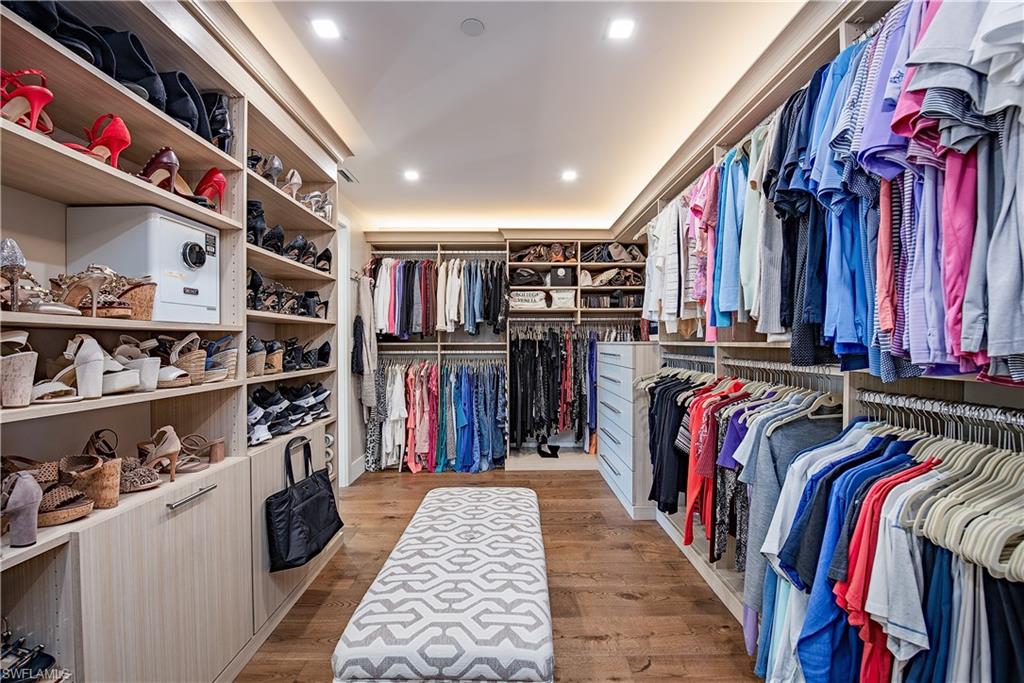 13915 Old Coast Road, Unit 602 Naples, FL 34110 - Photo 14 of 37 a view of walk in closet with clothes and shoes